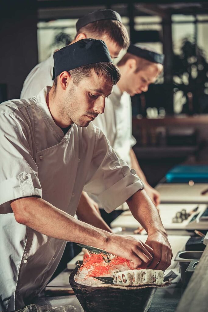 Chefs preparing dish in the MAKAI kitchen